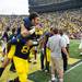 Michigan running back Drake Johnson is carried by tight end A.J. Williamsat at the end of the game over to the student section after being injured during the game, Saturday, Aug, 31.
Courtney Sacco I AnnArbor.com   